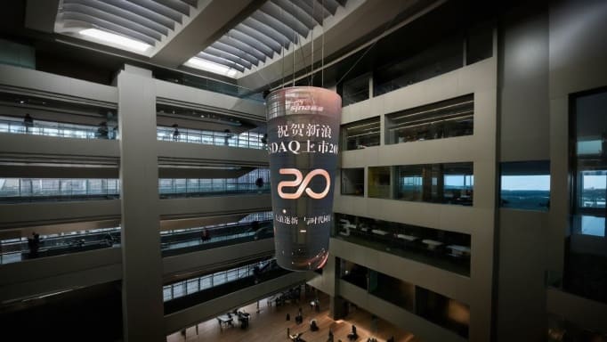 A Transparent Cylinder LED Display Suspended in the Center Creates a Futuristic Commercial Showcase